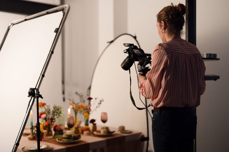 Marie Soehnlen prenant une photo de table mise en scène, derrière son appareil photo tenu avec un steadycam