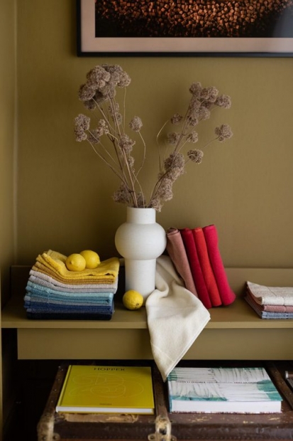 Serviettes colorées et citrons posés près d'un vase de fleurs séchées